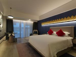 Postel nebo postele na pokoji v ubytování Tian Yi International Hotel 天艺国际酒店