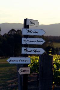 street signs on a pole at Blueberry Hill Vineyard Stay in Rothbury