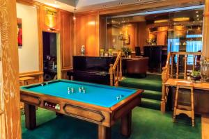 a billiard room with a pool table and a piano at Hotel Pacific in Ostend