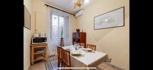 a dining room with a table with chairs and a microwave at Center Rome Coliseum in Rome