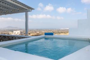 a swimming pool on the roof of a house at Seven Suites in Glinado Naxos