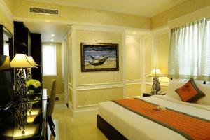 a hotel room with a bed and a window at Anpha Boutique Hotel in Ho Chi Minh City
