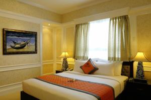 a hotel room with a bed and a window at Anpha Boutique Hotel in Ho Chi Minh City