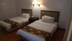 Uma cama ou camas num quarto em Excelsior Resort
