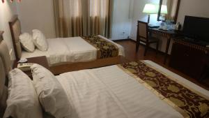 Uma cama ou camas num quarto em Excelsior Resort