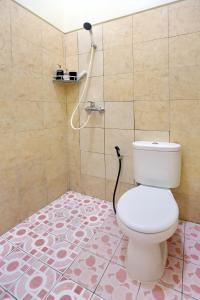 un baño con inodoro y ducha en Manda Homestay, en Sanur