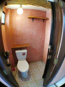 a small bathroom with a toilet in a room at 59Indy Guesthouse in Bangkok