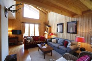 a living room with a couch and a table at Apartment Mélodie de Rêve in Crans-Montana