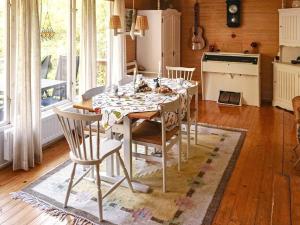 a kitchen with a table and chairs in a room at 6 person holiday home in SORUNDA in Norra Svärdsö