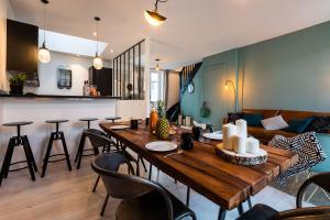 a living room with a wooden table and chairs at L'ATELIER KEYWEEK Vintage Duplex Apartment with Parking Biarritz Center in Biarritz
