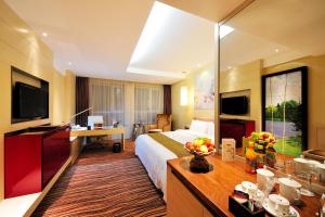 a hotel room with a large bed and a desk at Changchun Huatian Hotel in Changchun