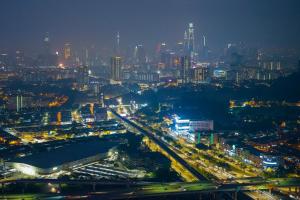 a view of a city at night with traffic at Cozy Modern Loft by De Lux @ EkoCheras, KL in Kuala Lumpur