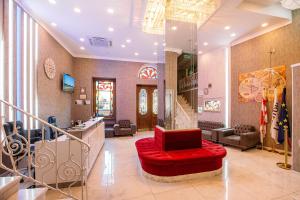 a large lobby with a red couch and a staircase at Hotel Aivani Old Tbilisi in Tbilisi City
