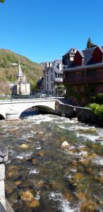 a bridge over a river in a town at La Maison d'Aure in Arreau