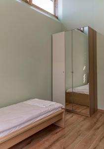 a bedroom with a bed and a mirror at Miego namai in Gargždai