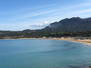 une grande étendue d'eau avec des montagnes en arrière-plan dans l'établissement Hotel de la Plage Santa Vittoria, à Algajola