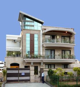 a man standing in front of a building at Hotel Golf View Suites-Golf Course Road Gurgaon in Gurgaon