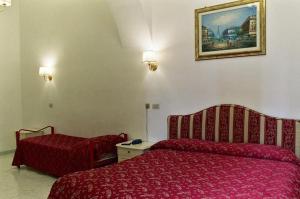 Postel nebo postele na pokoji v ubytování Hotel Euro Quiris