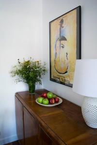 a table with a plate of fruit and a painting at NEAR TO THE CASTLE in Warsaw