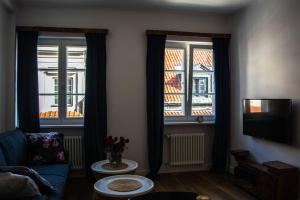 a living room with two windows and a couch at NEAR TO THE CASTLE in Warsaw