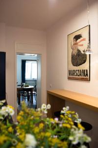 a living room with a table and a painting on the wall at NEAR TO THE CASTLE in Warsaw