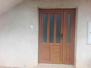 a wooden door on the side of a house at Apartman Mislav in Gračac