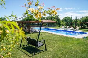 a yard with a swing and a swimming pool at Tefenni Villas & Hotel in Tefenni