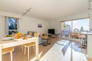 een keuken en een woonkamer met een tafel en stoelen bij Michel-Ange, Appartement avec Terrasse et Parking in Marseille