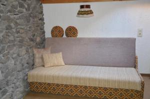 a bench in a room with a stone wall at Ferienhaus Antonia in Ehrwald