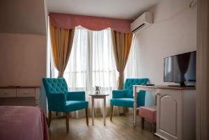 TV a/nebo společenská místnost v ubytování Hotel Coquette