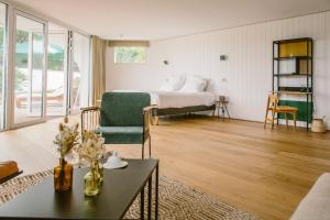 a bedroom with a bed and a living room at Les Hortensias du Lac - Fontenille Collection in Hossegor +50 photos