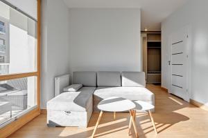 a living room with a couch and a table at Holiday Apartment near the Sea - free private parking in Gdańsk