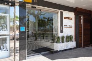 a store front with a glass door with plants in it at Prestige Mar y Sol in Roses