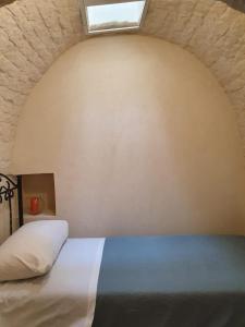 a bedroom with a bed with a skylight at I Trulli di Nonna Maria in Alberobello