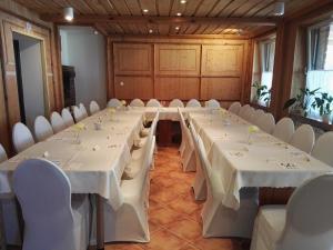 a conference room with white tables and white chairs at Akacjowy in Ostrowite