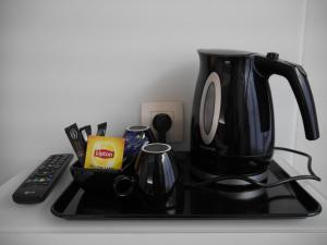 a coffee pot on top of a stove with a remote control at Hotel Best Western City Centre in Brussels