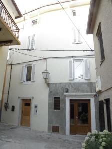a white building with a door and a street at Boutique Hotel Placa in Krk
