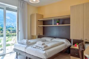 Postel nebo postele na pokoji v ubytování Hotel Roma