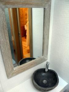 a bathroom sink with a mirror on a wall at Boutique Hotel Placa in Krk