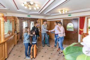 a group of people standing in a room at MyTime Hotels la Grotta in Vigo di Fassa