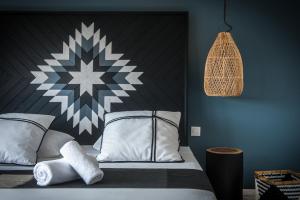 a bedroom with a bed with a black and white headboard at Indigo Inn in Hersonissos