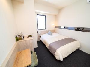 a bedroom with a large bed and a window at Super Hotel Premier Akihabara in Tokyo