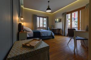 a bedroom with a bed and a table in a room at Central Rooms in Kalamata