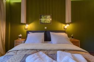 a bedroom with a bed and a lamp on the wall at Central Rooms in Kalamata