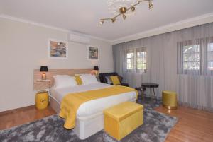 a bedroom with a large bed with a yellow blanket at Douro Prime Downtown in Vila Nova de Gaia