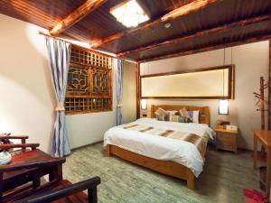 Postel nebo postele na pokoji v ubytování Nanjing Tulou Xinyuan HomeStay
