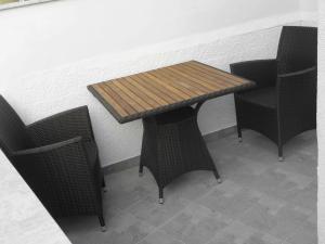 a wooden table and two chairs in a room at Boutique Hotel Placa in Krk