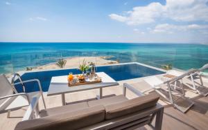 a table and chairs on a balcony with a view of the ocean at La Badira - Adult Only in Hammamet