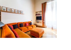 an orange couch in a living room with a window at Casa Rossella in Sorrento