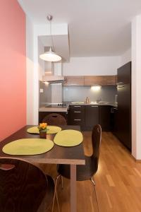 a kitchen with a table and chairs in a room at Aparthotel Angel in Prague